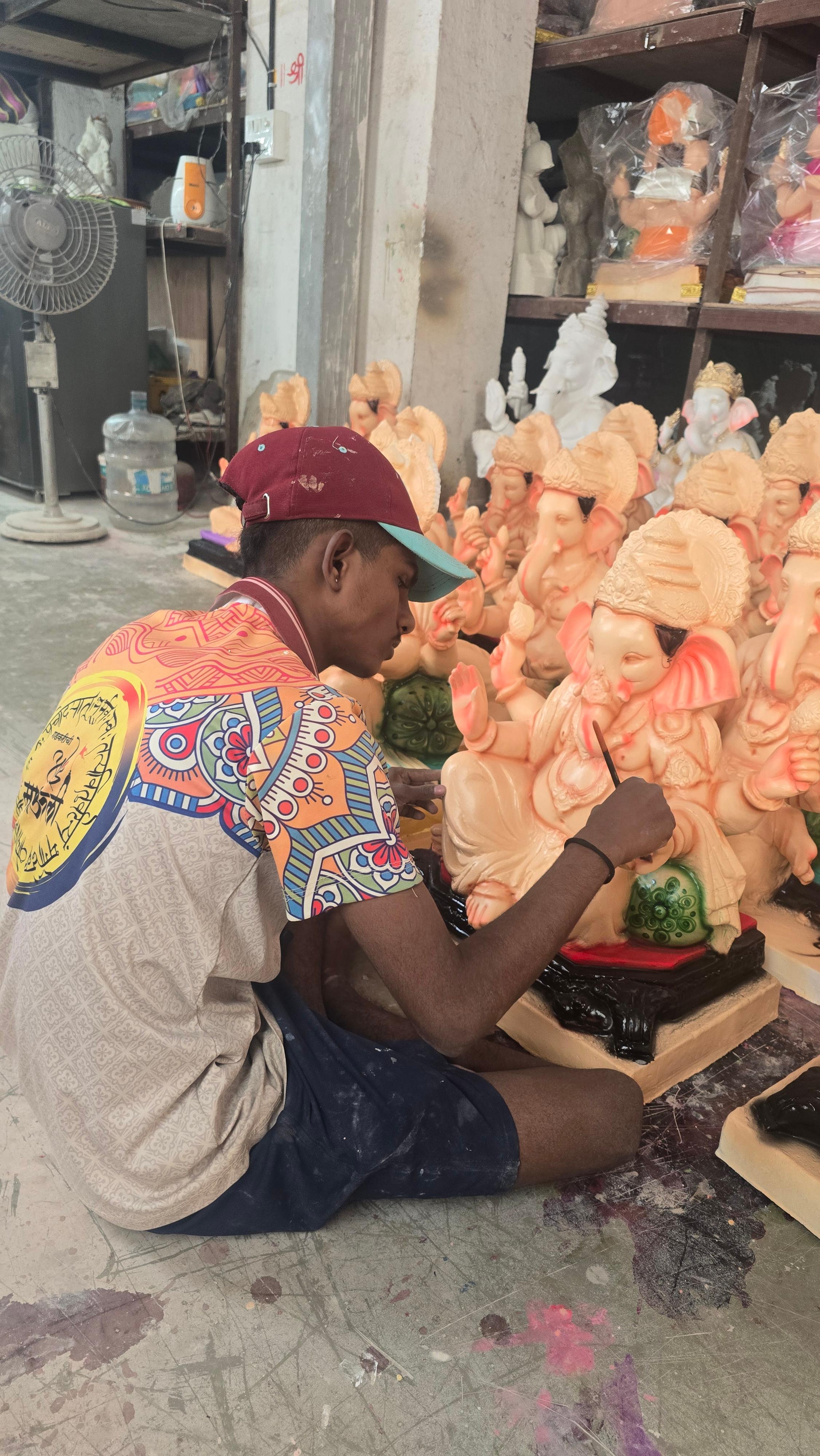 Artisans working on decorated Ganesha idols