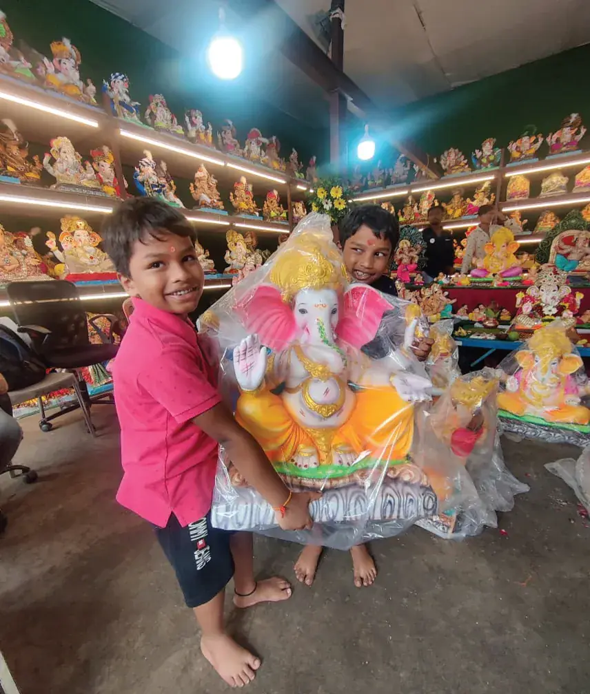 Children celebrating Ganesh Chaturthi with a Devta eco-friendly Ganesha idol