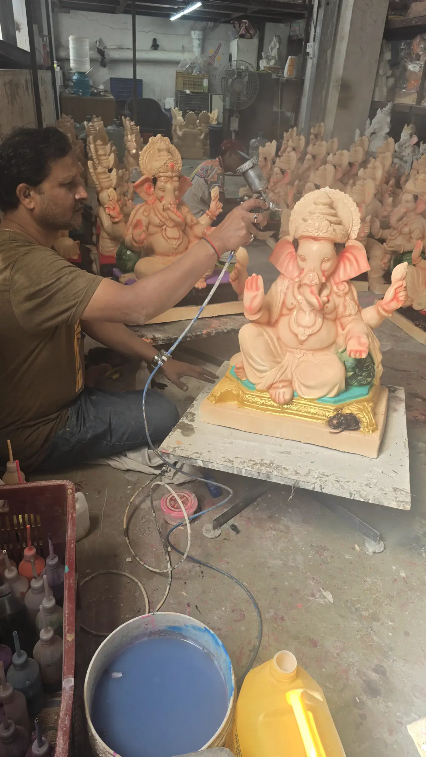 Devta artisan applying finishing touches to an eco-friendly Ganesha idol
